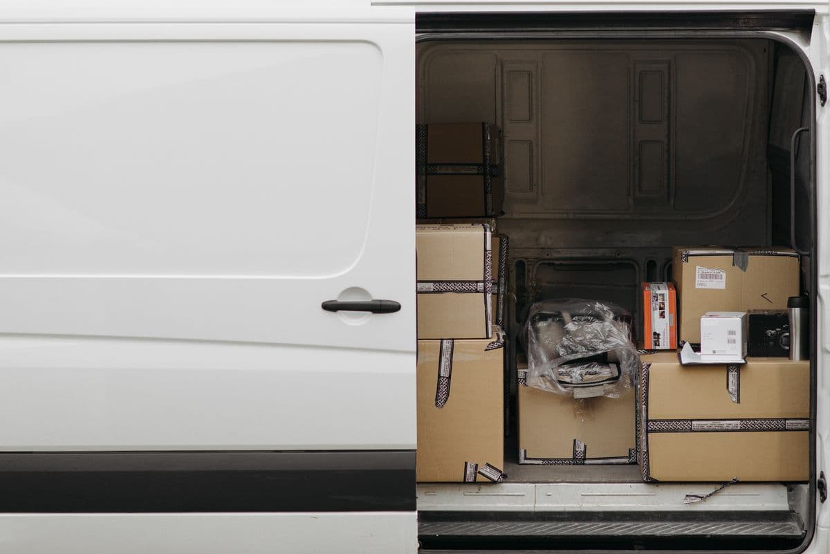 Open utility van loaded with boxes ready to be transported